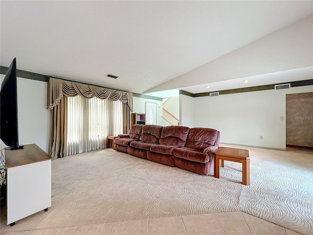 living room featuring vaulted ceiling and light tile patterned floors