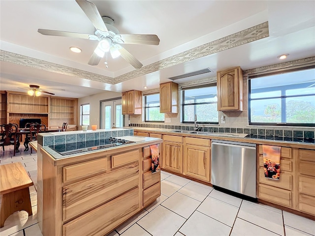 kitchen with appliances with stainless steel finishes, light tile patterned floors, and tasteful backsplash