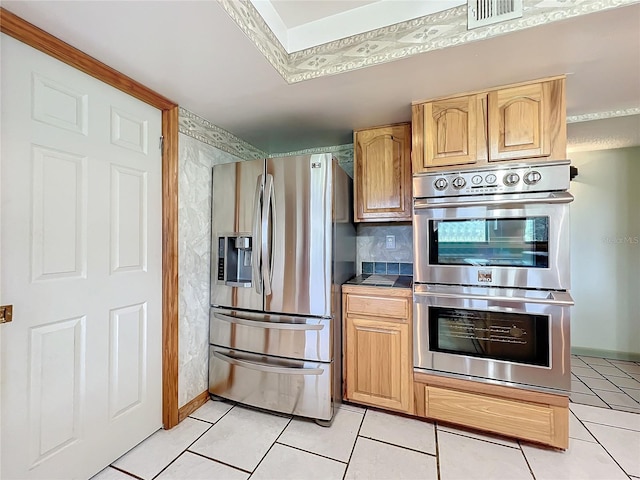 kitchen featuring stainless steel appliances and light tile patterned floors