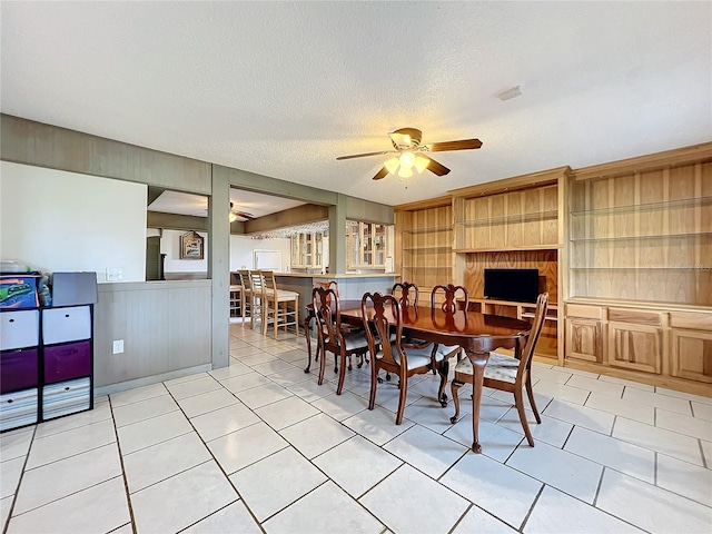 dining area featuring a textured ceiling and ceiling fan