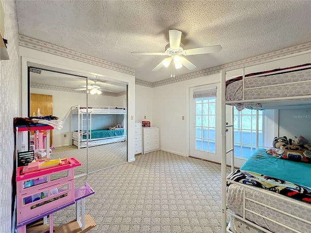 bedroom featuring light colored carpet, ceiling fan, crown molding, and a closet