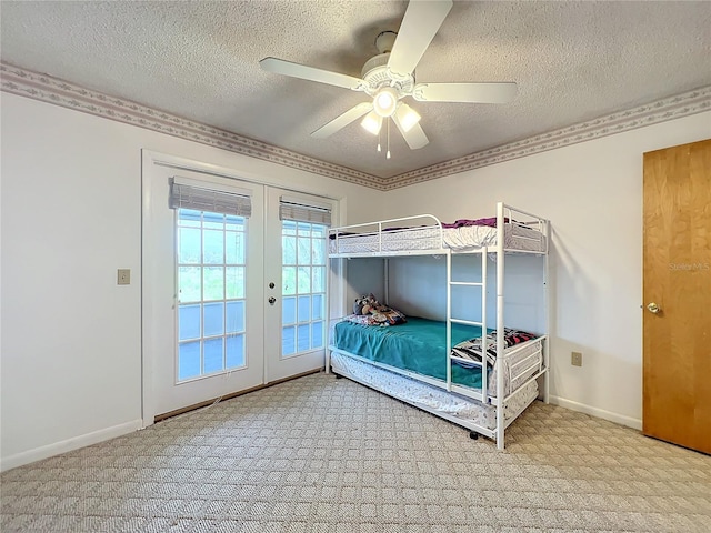 carpeted bedroom with access to outside, french doors, ceiling fan, and a textured ceiling