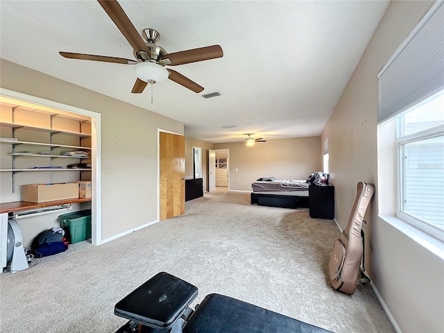 bedroom featuring carpet, ceiling fan, and a closet