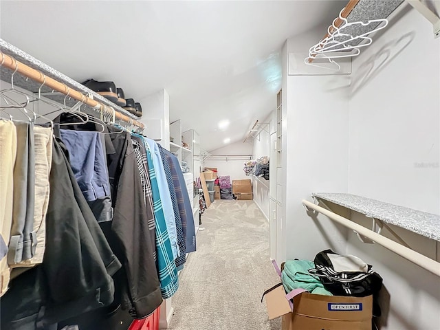 spacious closet featuring vaulted ceiling and light carpet