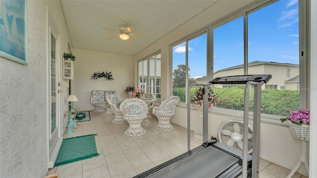 sunroom / solarium featuring ceiling fan