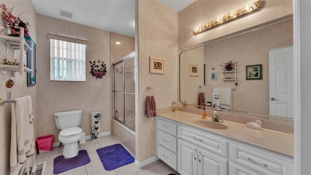 full bathroom with tile patterned flooring, vanity, toilet, and bath / shower combo with glass door