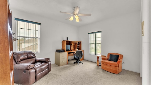 carpeted office with ceiling fan and a healthy amount of sunlight