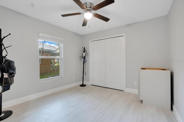 bedroom featuring ceiling fan, a closet, and light wood-type flooring