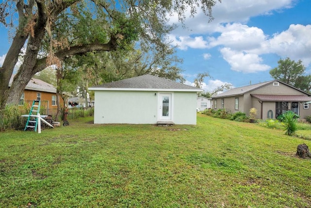 rear view of house with a lawn