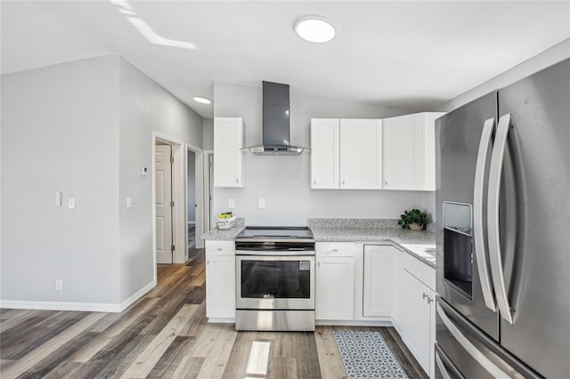 kitchen featuring white cabinetry, stainless steel appliances, wall chimney range hood, light stone counters, and dark hardwood / wood-style floors