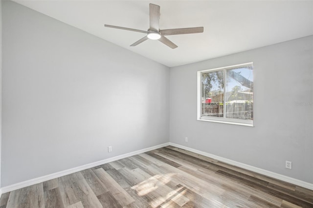 empty room featuring ceiling fan and light hardwood / wood-style flooring