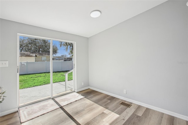 spare room featuring wood-type flooring