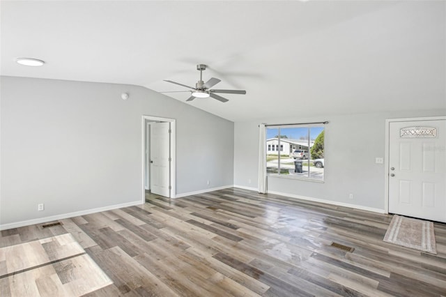 unfurnished living room with ceiling fan, wood-type flooring, and vaulted ceiling