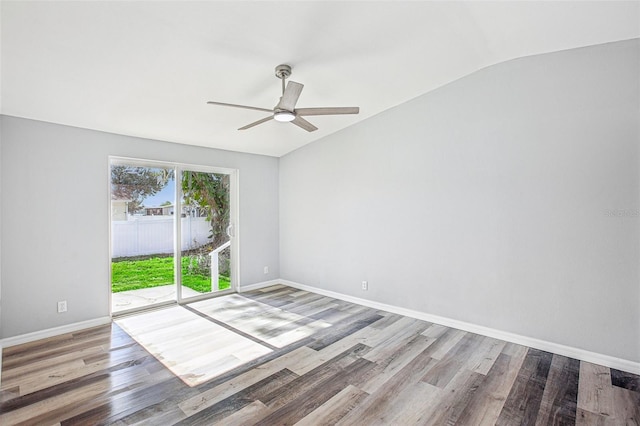 empty room with hardwood / wood-style floors, ceiling fan, and lofted ceiling