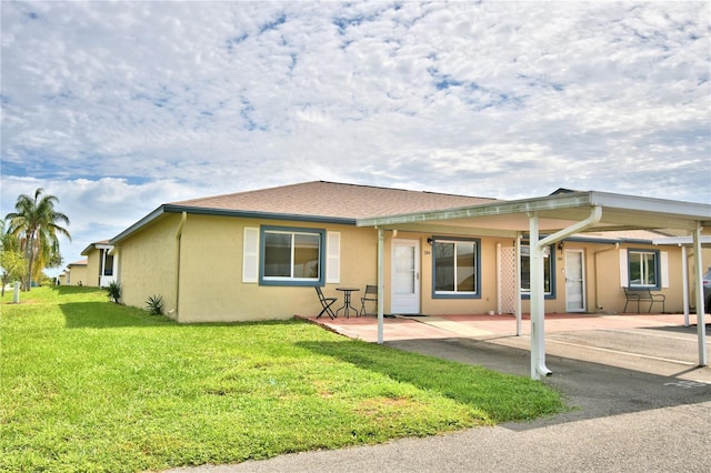 view of front of house with a patio area and a front lawn