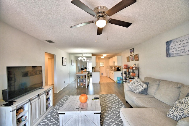 living room with light hardwood / wood-style floors and a textured ceiling