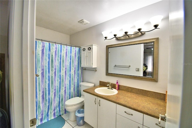 bathroom featuring toilet, vanity, tile patterned flooring, and walk in shower