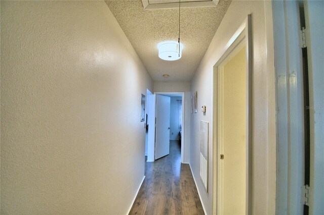 hall featuring dark hardwood / wood-style floors and a textured ceiling