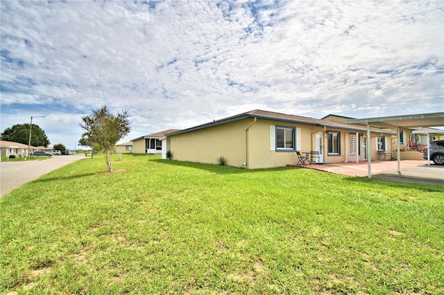 view of home's exterior featuring a yard and a carport