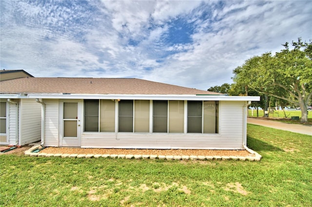 view of property exterior with a lawn