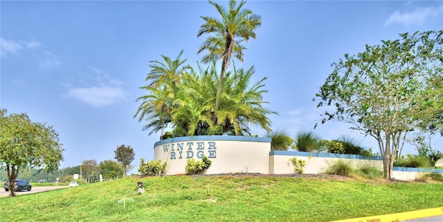 community / neighborhood sign with a lawn