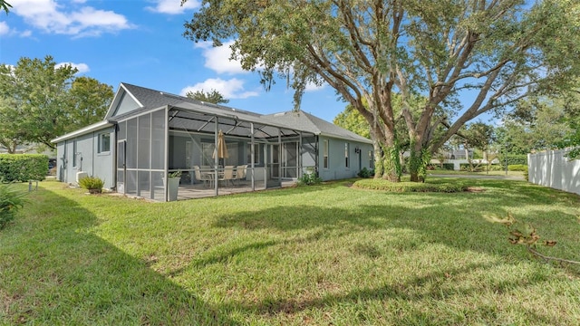 view of yard featuring glass enclosure and a patio