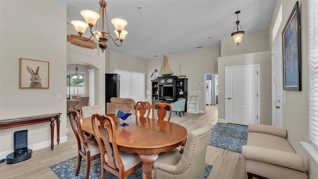 dining area featuring a chandelier and light hardwood / wood-style flooring