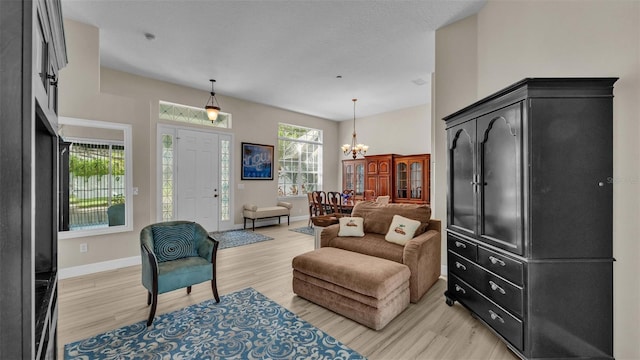 sitting room featuring a chandelier and light hardwood / wood-style flooring