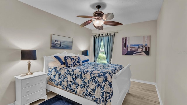 bedroom with ceiling fan and light wood-type flooring