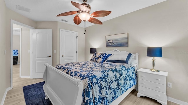 bedroom with ceiling fan and light wood-type flooring