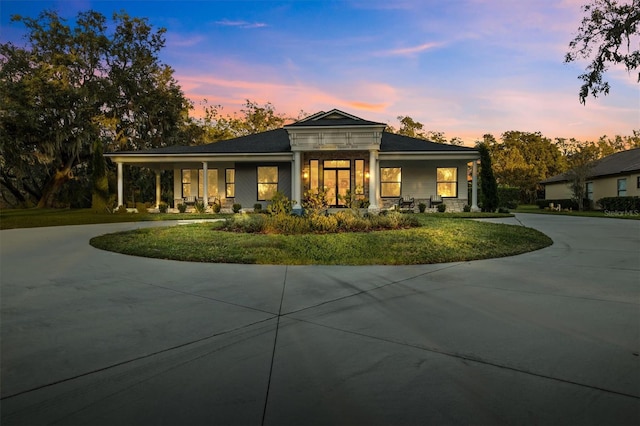 view of front of home featuring a yard and covered porch