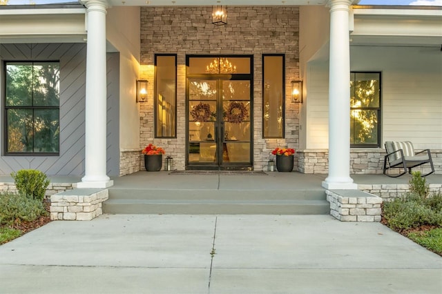 view of exterior entry with covered porch