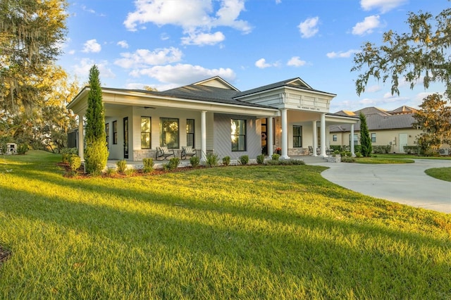 view of front of property with covered porch and a front lawn