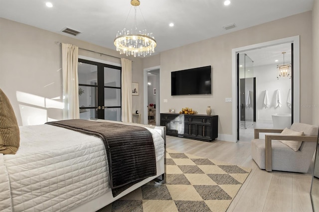 bedroom featuring french doors, ensuite bath, and light hardwood / wood-style floors