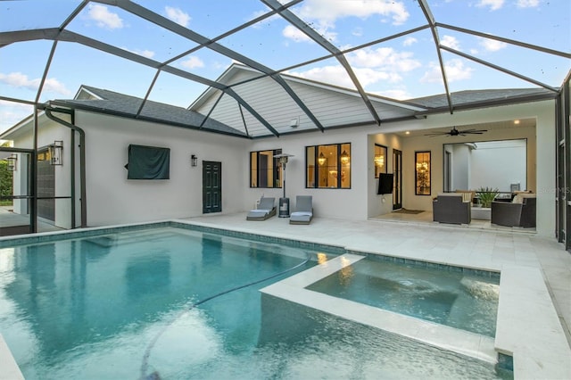 rear view of house with a patio, ceiling fan, glass enclosure, and a swimming pool with hot tub