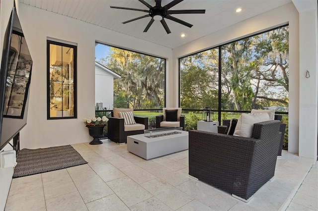 sunroom featuring ceiling fan