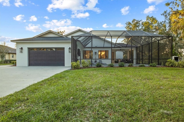 view of front of home with a front lawn, a lanai, and a garage