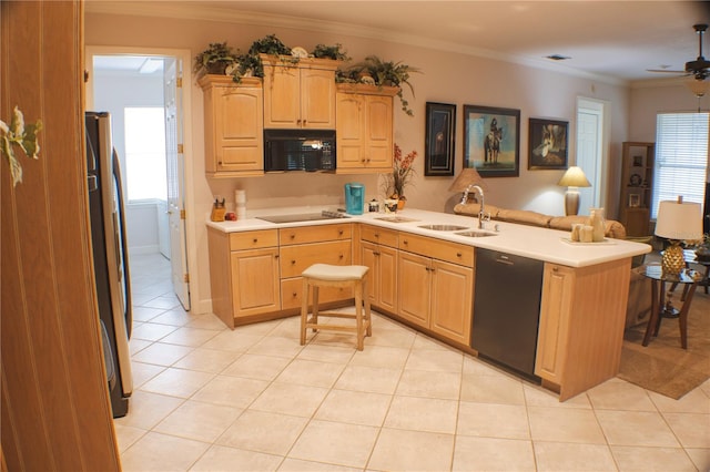 kitchen with a kitchen bar, kitchen peninsula, black appliances, sink, and crown molding