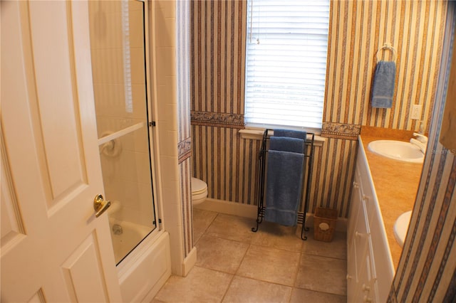 full bathroom with toilet, vanity, tile patterned flooring, and enclosed tub / shower combo