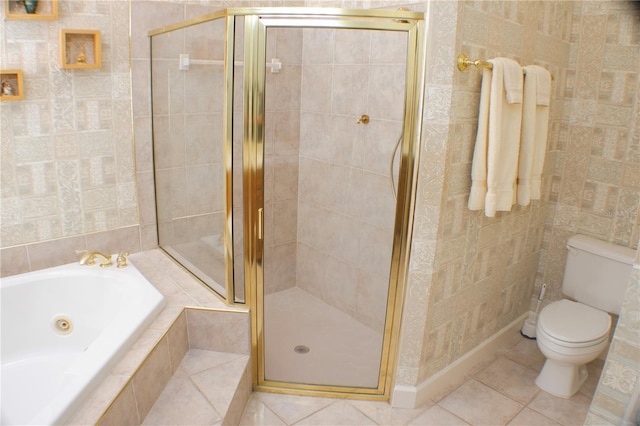 bathroom with tile walls, tile patterned floors, toilet, and independent shower and bath