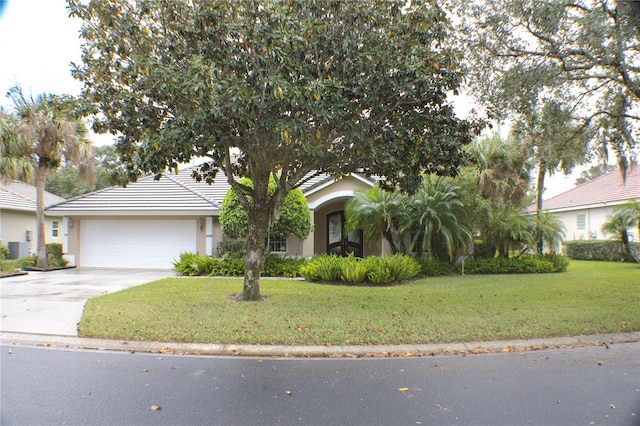 view of front of house with a garage and a front lawn