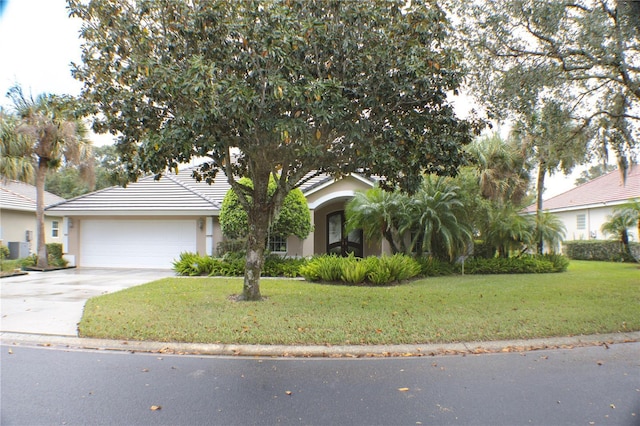 108 Lake Region Blvd N, Winter Haven, FL 33881 - view of front of property with an attached garage, concrete driveway, a front yard, and stucco siding