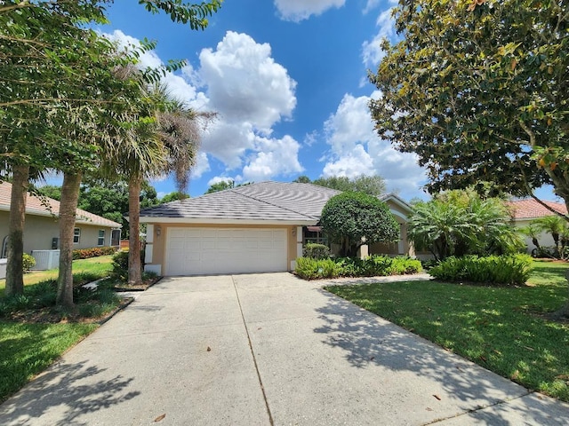 108 Lake Region Blvd N, Winter Haven, FL 33881 - single story home featuring a front yard, driveway, an attached garage, and stucco siding