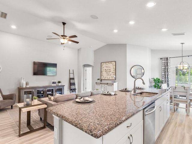 kitchen with light hardwood / wood-style floors, lofted ceiling, sink, stone countertops, and white cabinetry