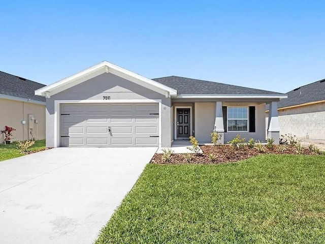 ranch-style home featuring a garage, concrete driveway, a front lawn, and stucco siding