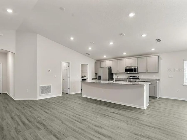 kitchen featuring light wood-style floors, visible vents, gray cabinets, and stainless steel appliances