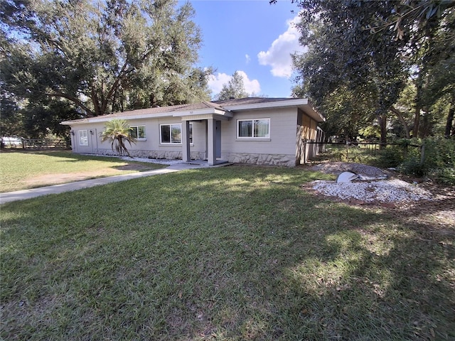 ranch-style home featuring a front yard