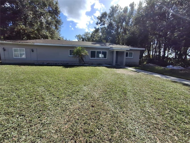 ranch-style home featuring a front yard