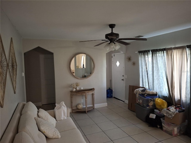 tiled living room featuring ceiling fan