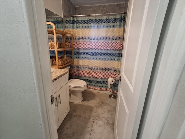 bathroom with toilet, vanity, tile patterned flooring, and curtained shower